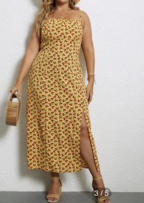 A yellow dress with cherries printed all over